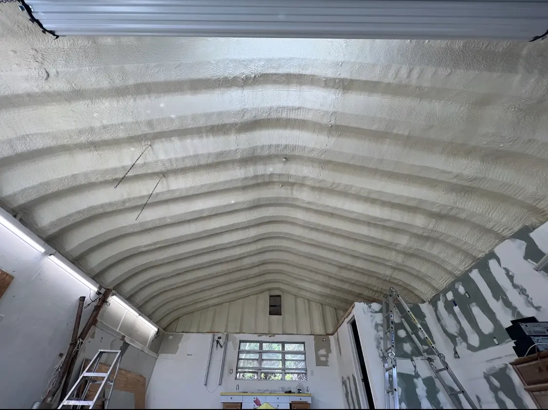 Spray polyurethane foam applied to the underside of a metal roof deck in Reston